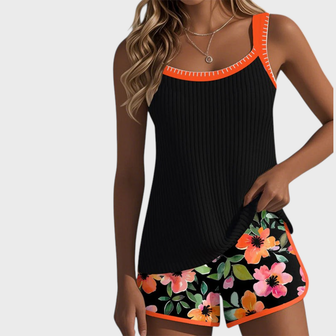 Tankini de duas peças Liselotte Salzburg com top preto canelado e calções com padrão floral colorido e detalhes laranja