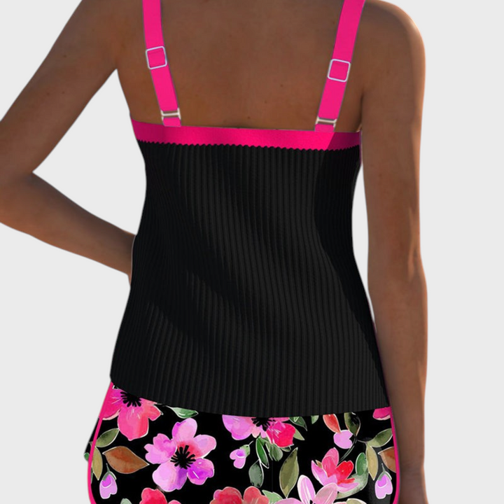 Vista traseira do tankini Liselotte Salzburg Élise com top preto canelado, alças rosa e cueca com estampado floral.
