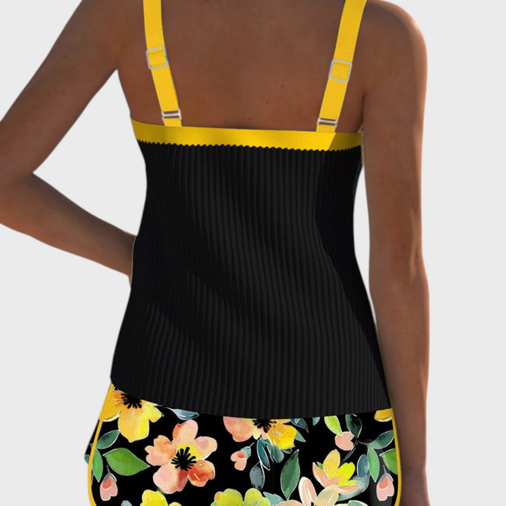 Tankini de duas peças Liselotte Salzburg com top preto canelado, alças amarelas e cueca com padrão floral colorido
