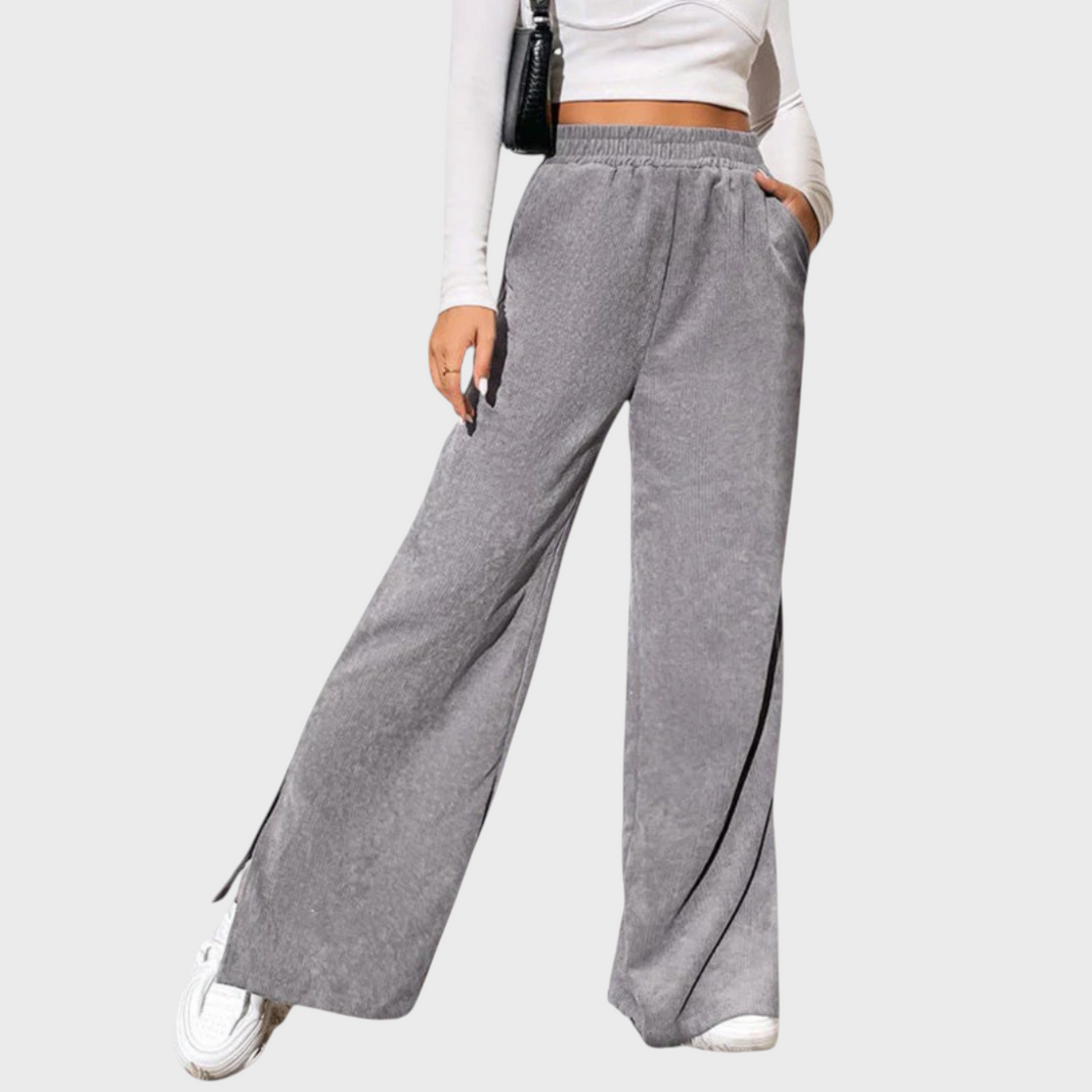 Calças largas cinzentas Liselotte Salzburg com cintura elástica, bolsos laterais e textura canelada suave.