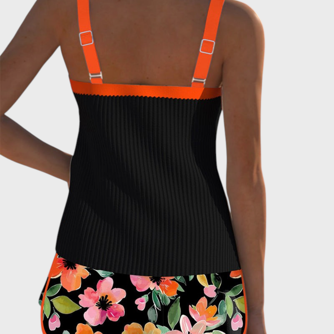 Vista traseira do tankini Liselotte Salzburg Élise com top preto canelado, alças laranja e cueca com estampado floral