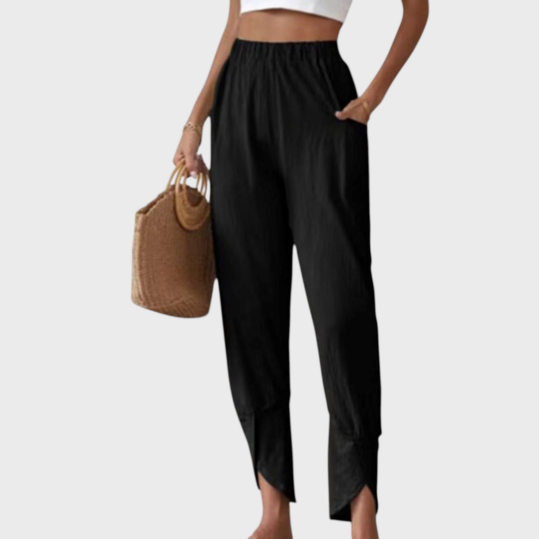 Calças pretas Liselotte Salzburg com bainha com racha, cintura elástica e tecido texturizado, estilo casual elegante.
